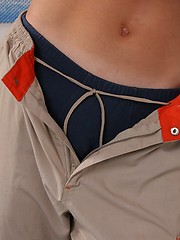 Athletic teen boy undress his shirt and pants