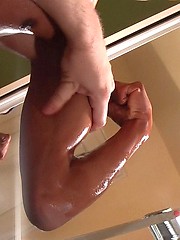 Hot oiled jock bump his muscles