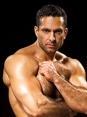 Fitness guy shows his strong haired chest