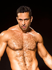 Fitness guy shows his strong haired chest