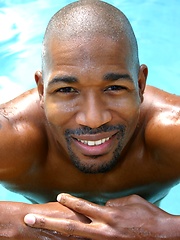 Black man posing by the pool