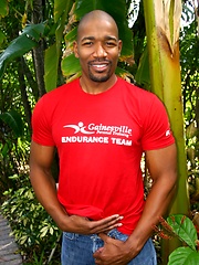 Black man posing by the pool