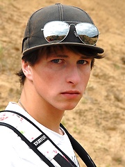 Nude skinny boy playing in the sand