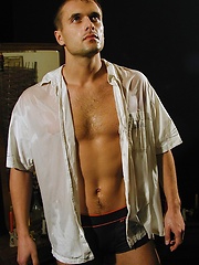 Ripped stud Ronny strokes his cock on the bed.