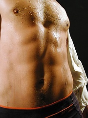 Ripped stud Ronny strokes his cock on the bed.