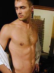 Ripped stud Ronny strokes his cock on the bed.