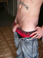 Tattooed Kyle Collins stroking his small cock.